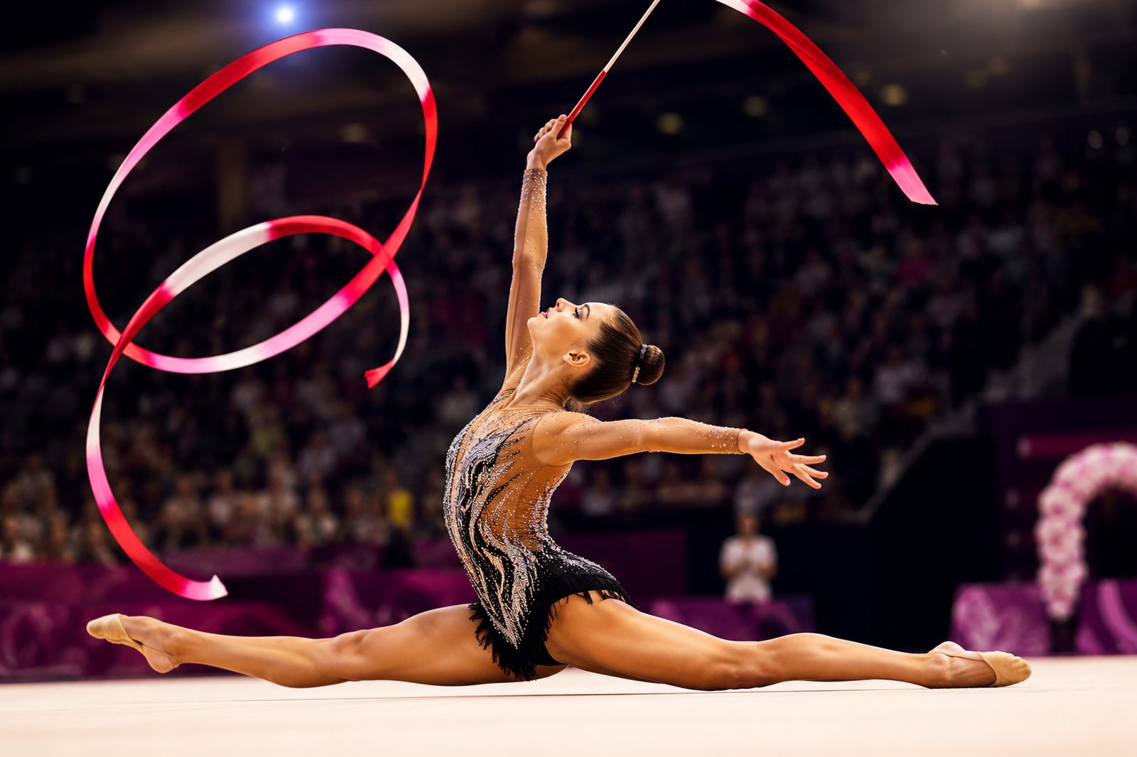 Rhythmic gymnast performing a ribbon routine in full split